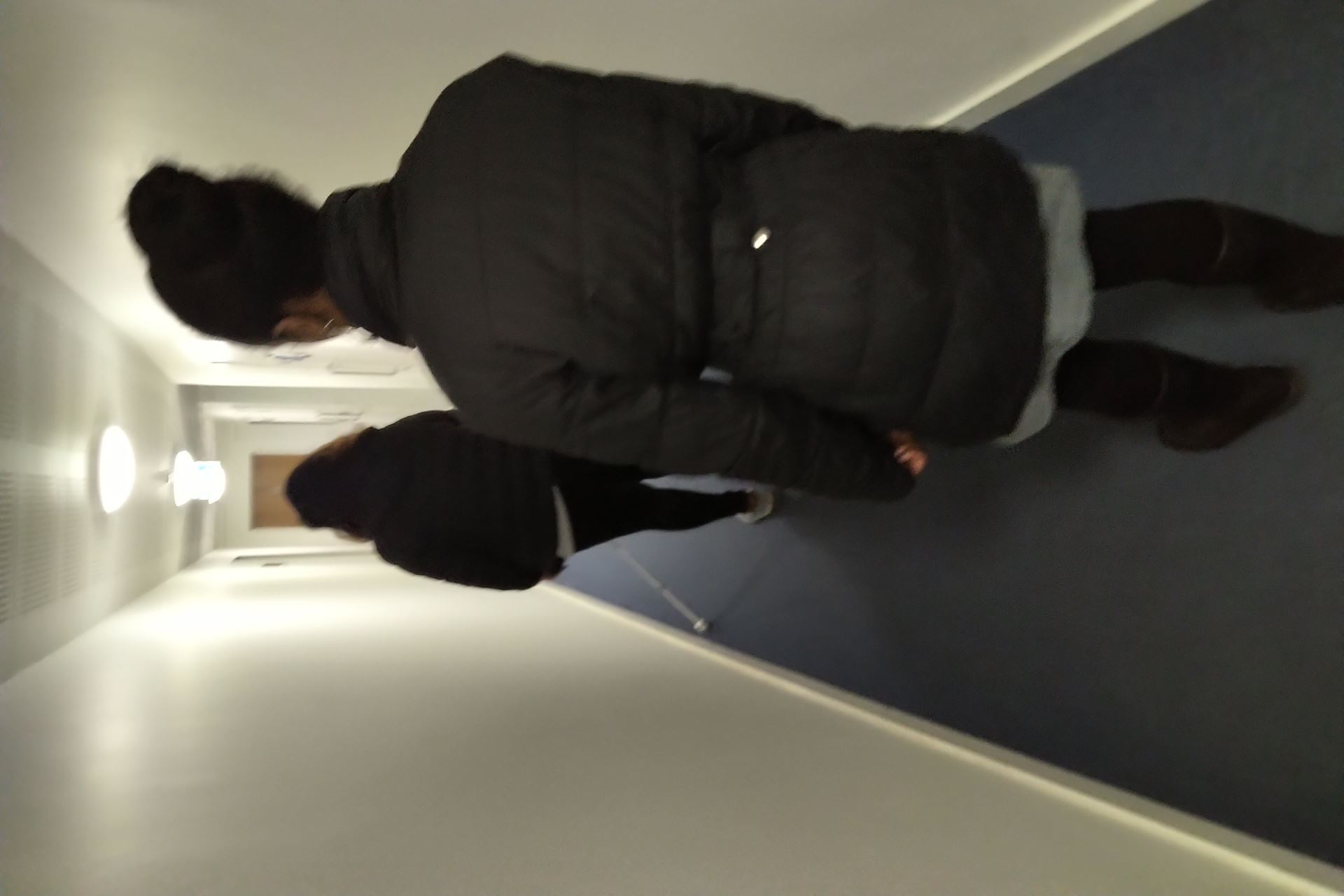 image of VRS walking behind a client along a corridor, teaching long cane